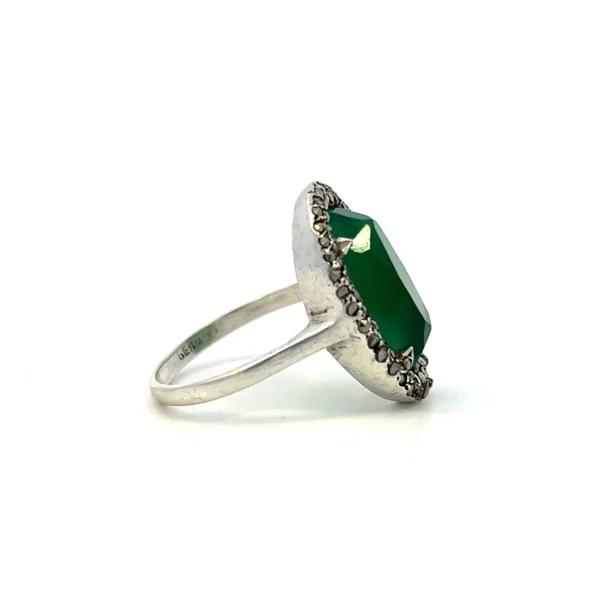 One estate sterling silver ring with an oval cabochon chrysoprase surrounded by a double halo of round-faceted marcasite in pave settings.