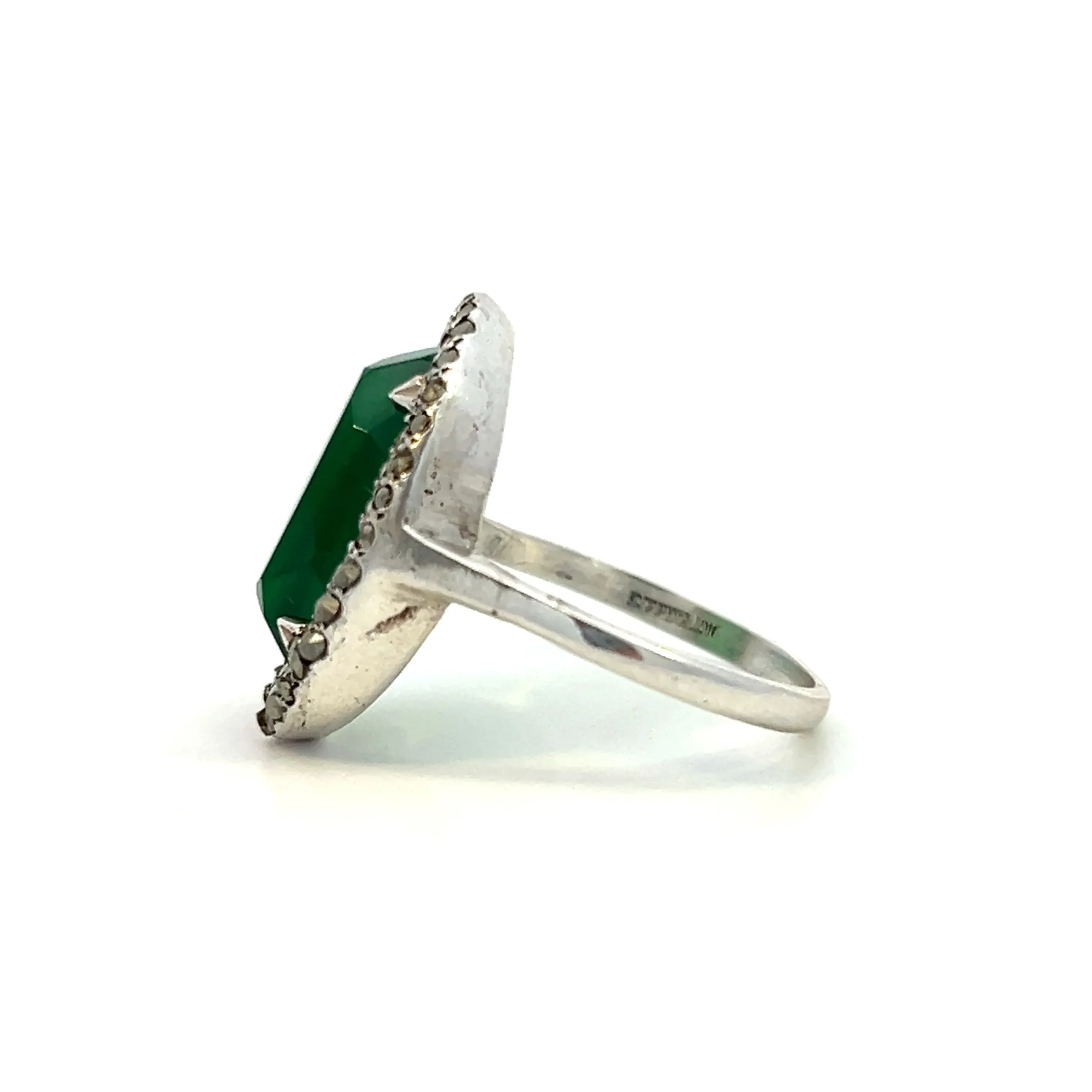 One estate sterling silver ring with an oval cabochon chrysoprase surrounded by a double halo of round-faceted marcasite in pave settings.