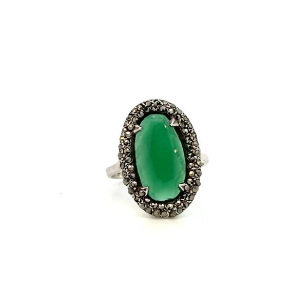 One estate sterling silver ring with an oval cabochon chrysoprase surrounded by a double halo of round-faceted marcasite in pave settings.