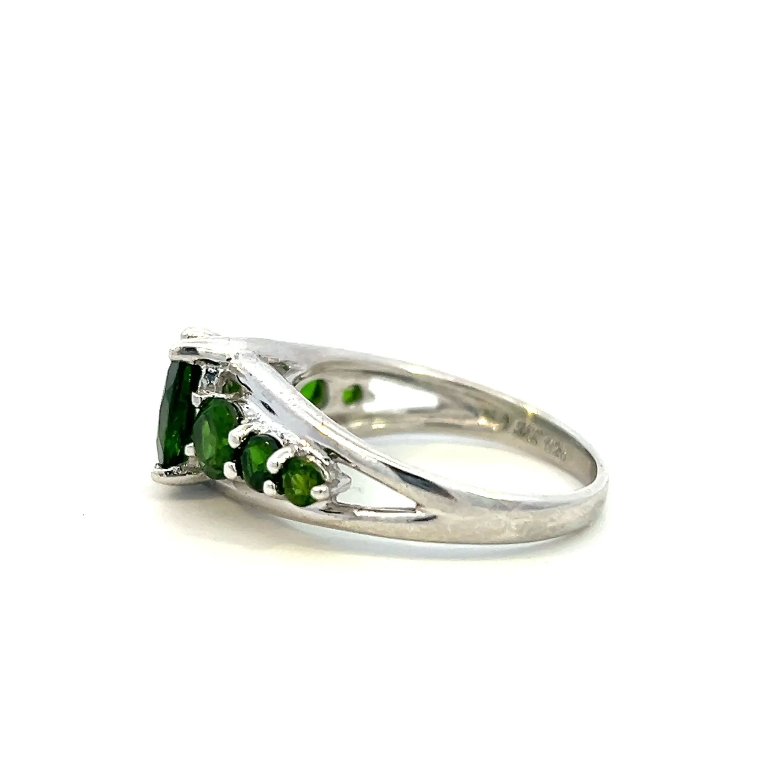 One estate sterling silver quartz ring with a center oval dark green quartz with 3 round dark green quartzes set in each shoulder of the band in graduating sizes.