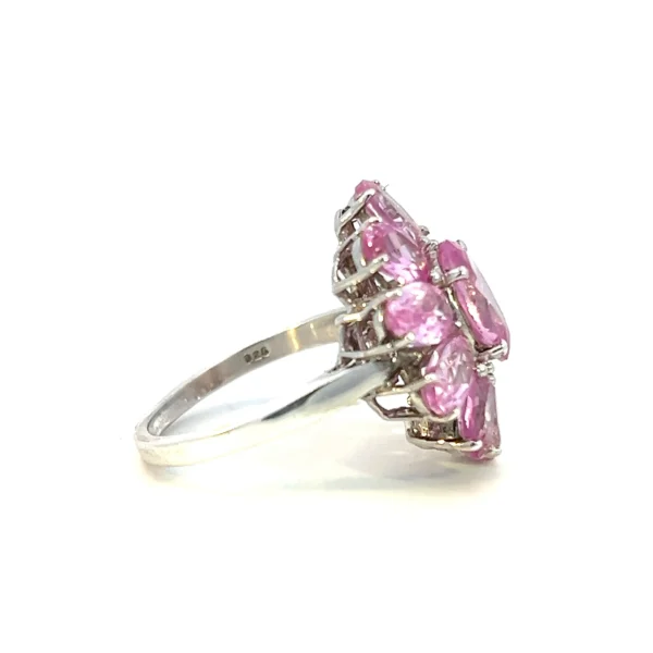 One estate sterling silver lab-created pink sapphire flower ring featuring a 11 oval-shaped faceted lab-crated pink sapphires in a floral design resembling a pink lily, azalea, or cosmos flower.