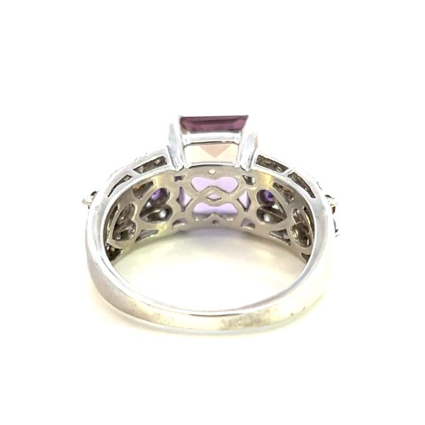 One estate ametrine fashion ring crafted from sterling silver with a center emerald-cut ametrine measuring 8x10mm. The band features 4 rows of gemstones with the outer two rows being 1mm round white sapphires, one inner row being 1.5mm round amethysts, and the other inner row being 1.5mm round citrines.