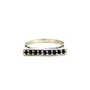 One estate blue sapphire bar ring crafted from sterling silver and featuring 9 round blue sapphires measuring 1.8mm each pave-set in an east-west bar on the top of the ring.