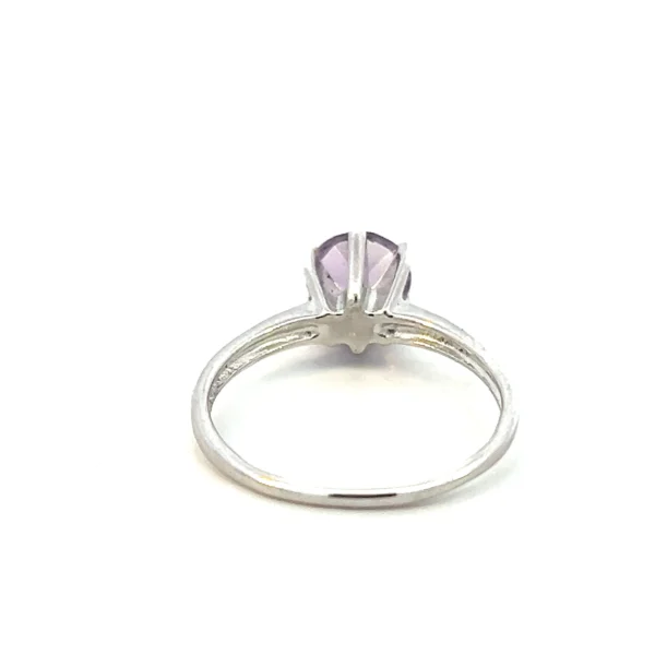 One estate round amethyst ring crafted from sterling silver containing a 7mm round light purple amethyst in a six-prong setting with a slender band.