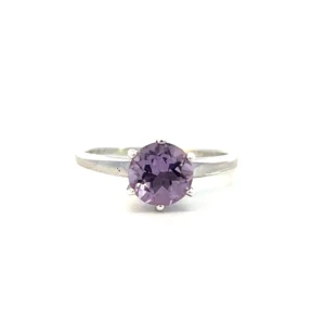 One estate round amethyst ring crafted from sterling silver containing a 7mm round light purple amethyst in a six-prong setting with a slender band.