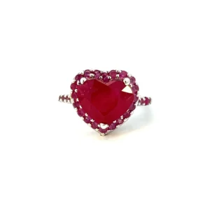 One Estate Lab-Created Ruby Heart Ring crafted from sterling silver containing a lab-created heart-shaped ruby surrounded by a halo of 20 lab-created round rubies with 6 lab-created round rubies in the shoulders. the center ruby measures 11.70x10mm and the round rubies measure 1.5mm.