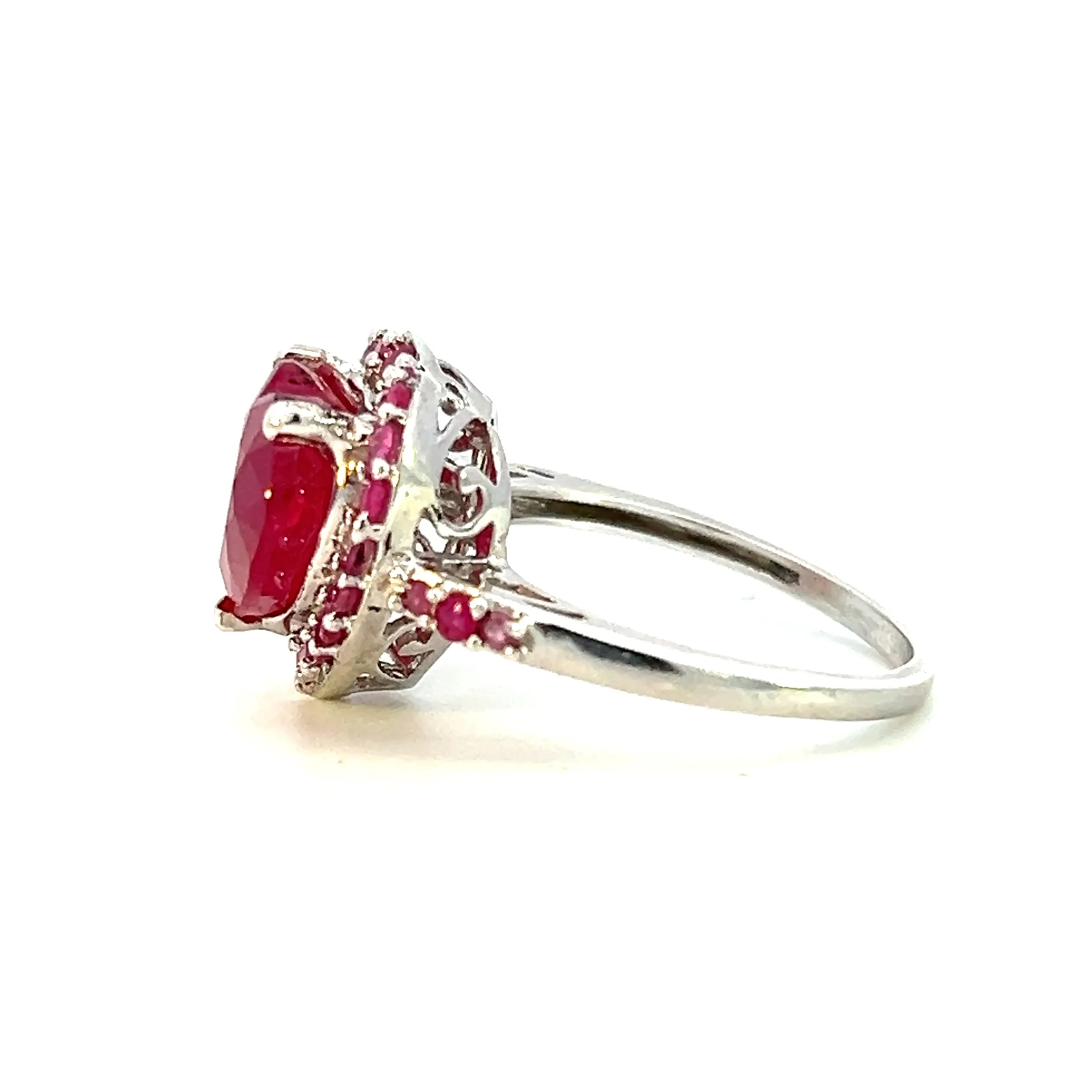 One Estate Lab-Created Ruby Heart Ring crafted from sterling silver containing a lab-created heart-shaped ruby surrounded by a halo of 20 lab-created round rubies with 6 lab-created round rubies in the shoulders. the center ruby measures 11.70x10mm and the round rubies measure 1.5mm.