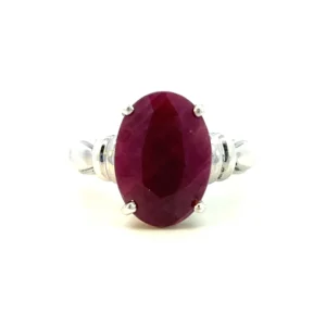 Estate sterling silver ring with an oval-shaped faceted lab-created ruby and fluted accents.