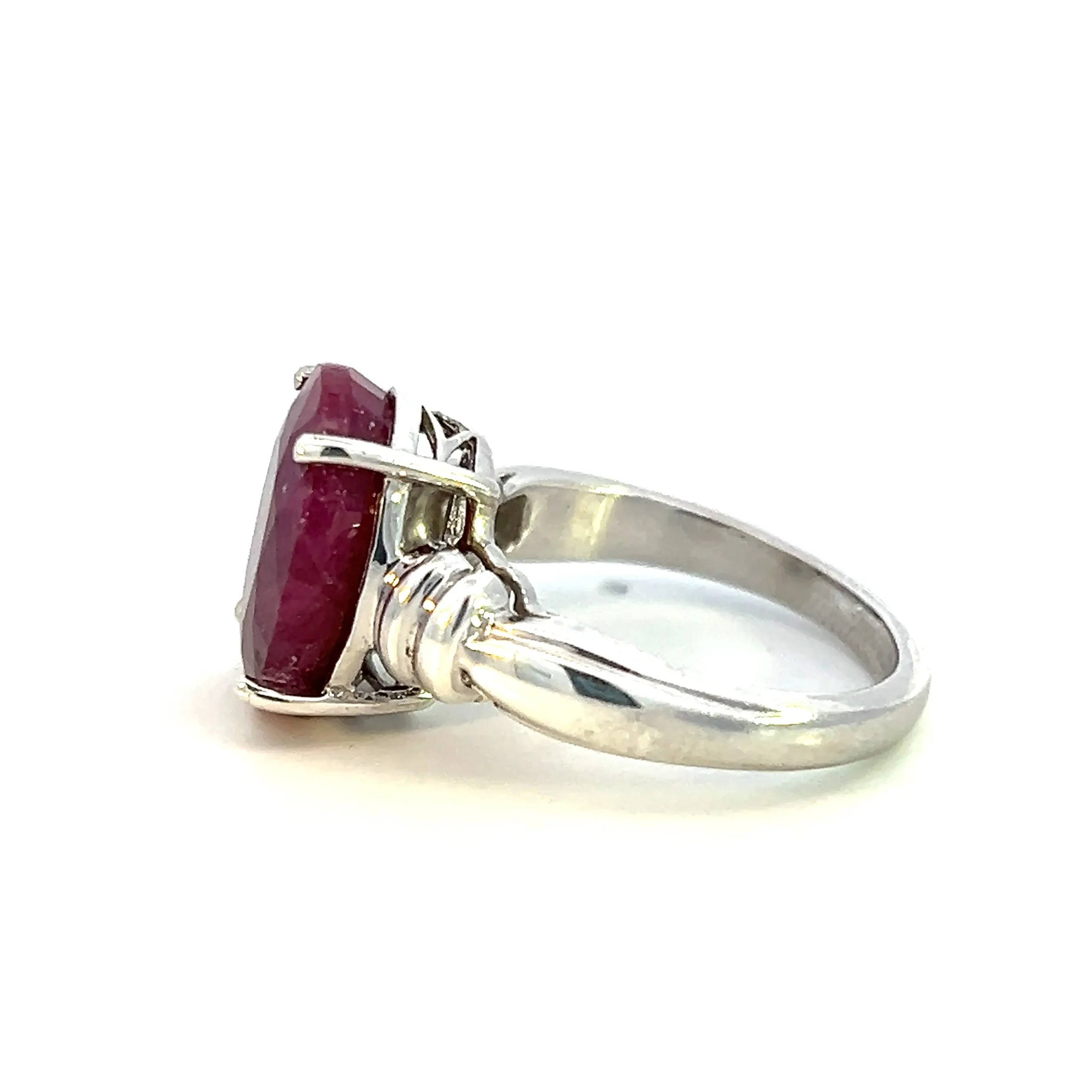Estate sterling silver ring with an oval-shaped faceted lab-created ruby and fluted accents.
