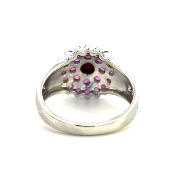 One estate sterling silver cluster ring containing 26 round rubies in a 2 halo cluster floral design.