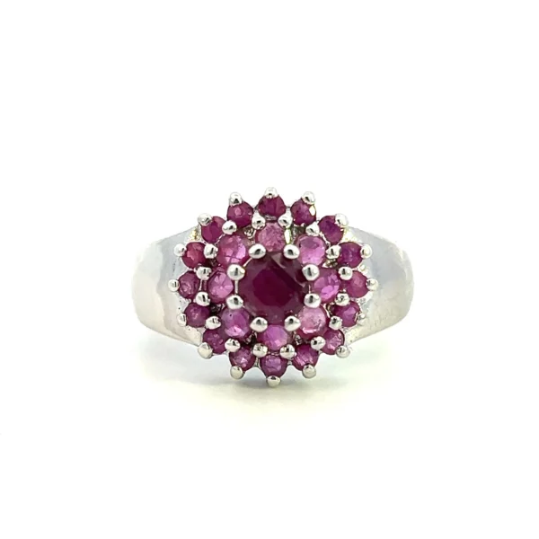 One estate sterling silver cluster ring containing 26 round rubies in a 2 halo cluster floral design.