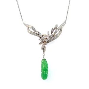 Estate Vintage 14K White Gold Necklace with a carved green jadeite dangle and round diamond accents in a nature-inspired design.