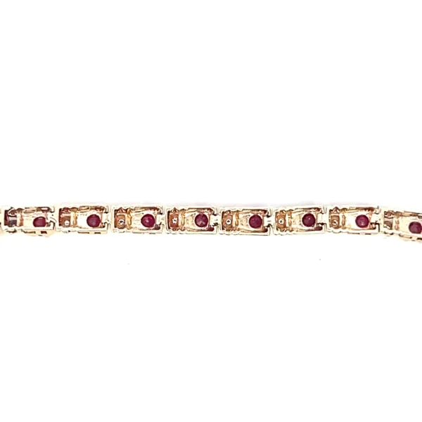 One estate 10 karat yellow gold ruby and diamond tennis bracelet with alternating between 21 round rubies measuring 2.80mm each and 21 round brilliant diamonds weighing 0.15 carat total weight. The bracelet measures 7" long with a lobster claw clasp.