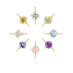A collection of 14 karat yellow gold permanent jewelry gemstone charms by Aurelie Gi