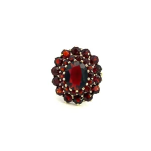 Estate Vintage Garnet Cluster Ring - stamped 333 4.39g one (1) estate 8 karat yellow gold ring set with one (1) center oval garnet weighing 2.32 carats surrounded the 2 halos of round garnets. The inner halo has fourteen (14) round garnets weighing 0.98 total carat weight and the outer halo has fourteen (14) round garnets weighing 2.38 total carat weight. From the 1960s. Ring size 6.5.
