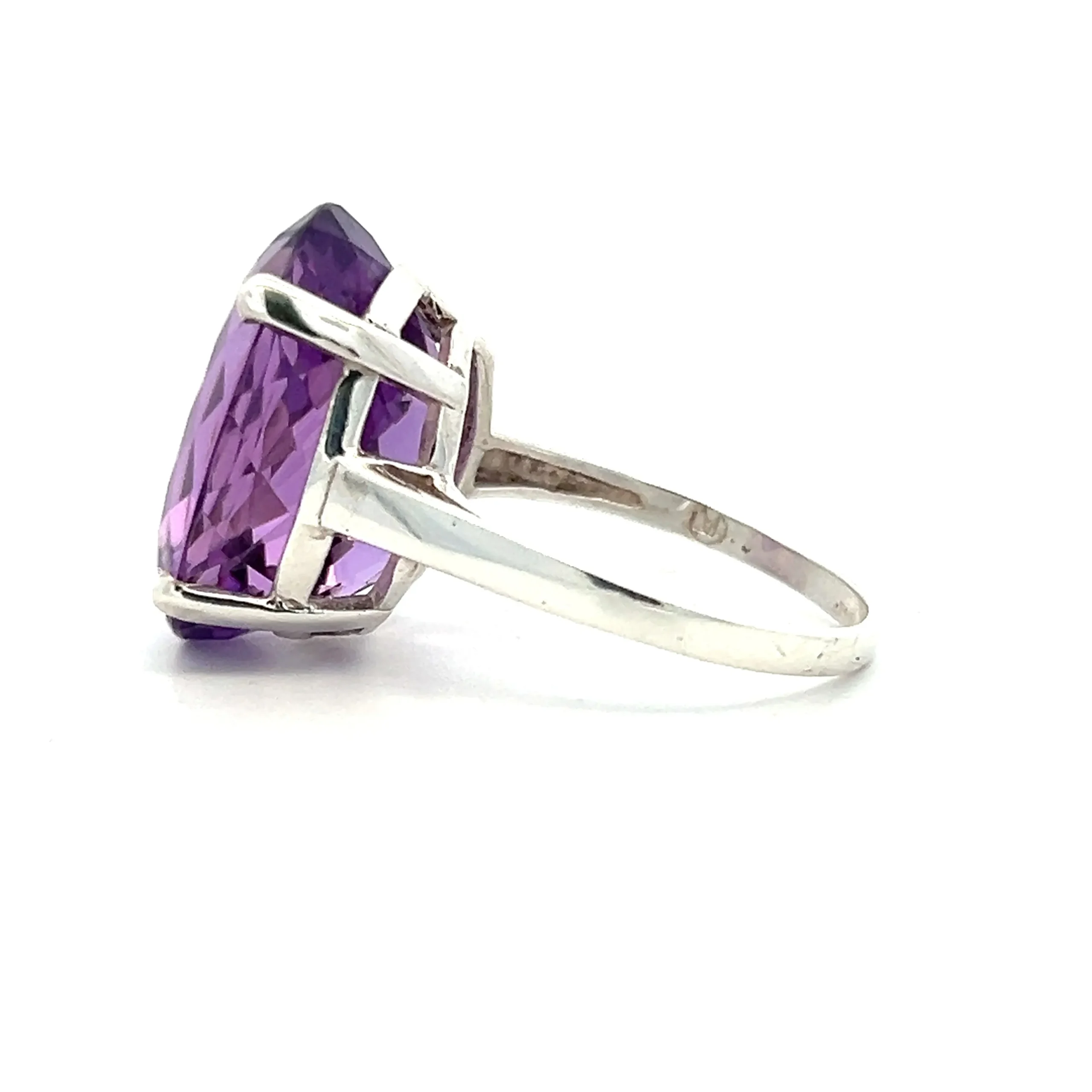 One estate sterling silver solitaire ring containing one oval-shaped faceted amethyst weighing 0.38 carat in a four-prong setting.