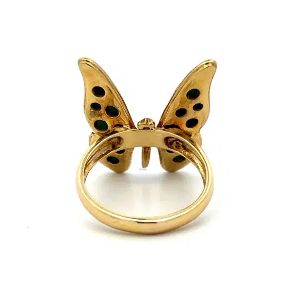 One estate 8 karat yellow gold butterfly ring set with 4 custom cut pieces of malachite in the 4 sections of the butterfly's wings. From the 1980s.