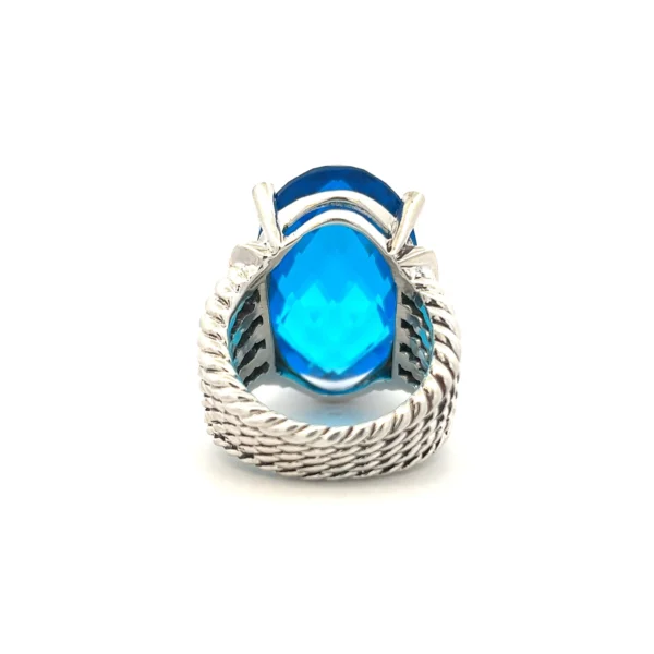 One estate sterling silver David Yurman ring containing a center oval-shaped faceted piece of blue glass measuring 26x16mm and containing 20 lab-created round brilliant diamonds weighing 0.15 carat total weight with G-H color and VS clarity with 10 diamonds to the east and west of the blue glass in a very partial halo design. The band is comprised of 5 rope texture bands that create a slight multi split shank design and remain separate all the way around the band but taper closer together at the bottom of the ring. Total weight of 16.50 grams. size 6.75. stamped D.Y. 925.