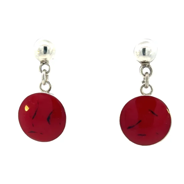 One estate pair of sterling silver drop earrings containing two round pieces of red enamel with subtle black accents in bezel settings. Stamped 925. Total weight 14.34 grams.