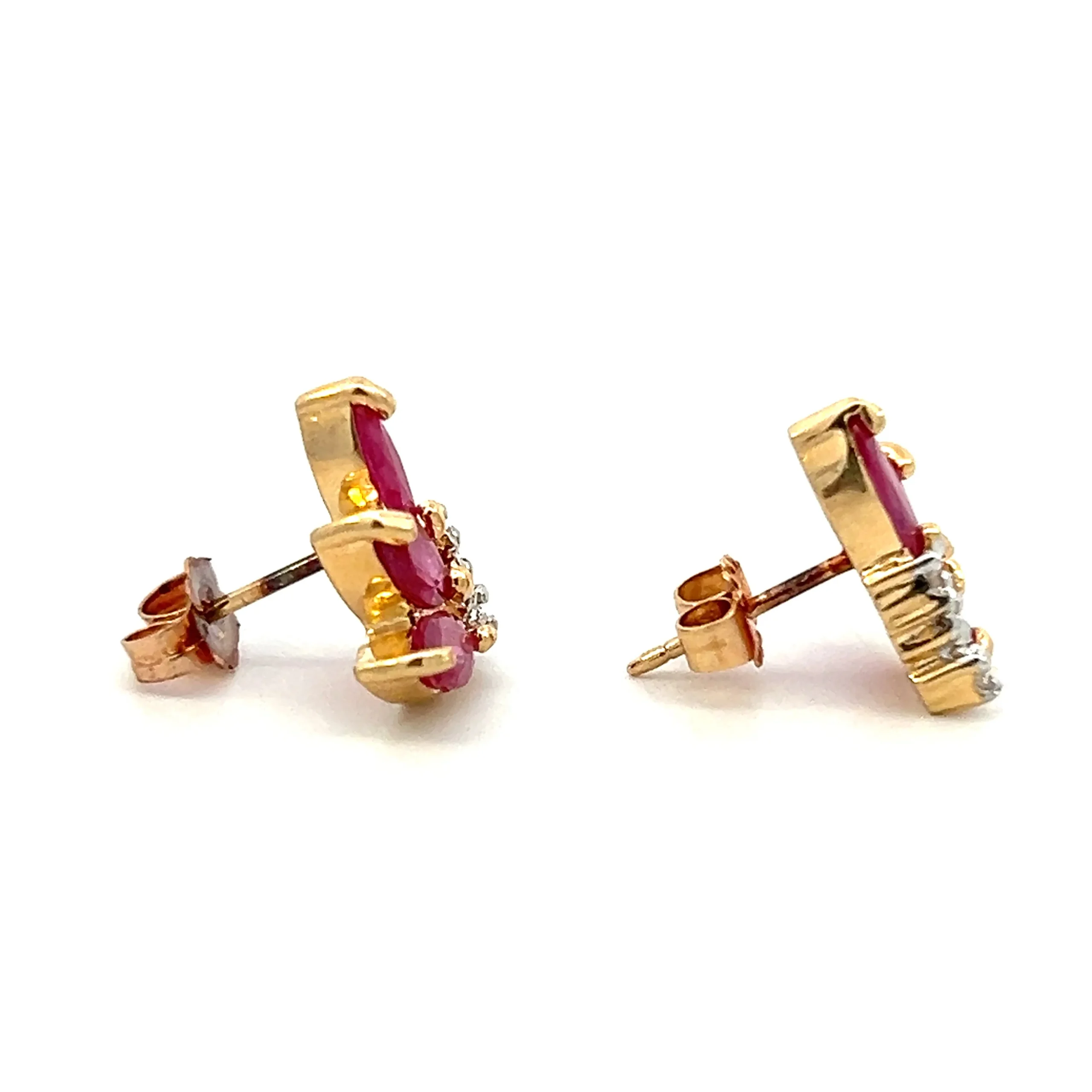 ne estate pair of 14 karat yellow gold stud earrings set with 6 marquise synthetic rubies weighing 1.24 total carat weight and 6 round brilliant diamonds weighing 0.03 total carat weight with matching j color and i2 clarity. Each earring is arranged in such a way to give an impression of a tropical flower or flamelike appearance. secured with friction posts and backs.