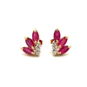 ne estate pair of 14 karat yellow gold stud earrings set with 6 marquise synthetic rubies weighing 1.24 total carat weight and 6 round brilliant diamonds weighing 0.03 total carat weight with matching j color and i2 clarity. Each earring is arranged in such a way to give an impression of a tropical flower or flamelike appearance. secured with friction posts and backs.