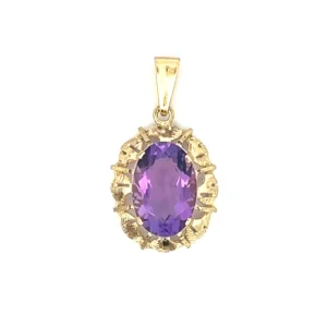 One 8 karat yellow gold amethyst pendant from the 1960s containing one oval faceted amethyst measuring 16x11mm in an open-work gold frame. The entire pendant including the bail measures 33x18.54mm.