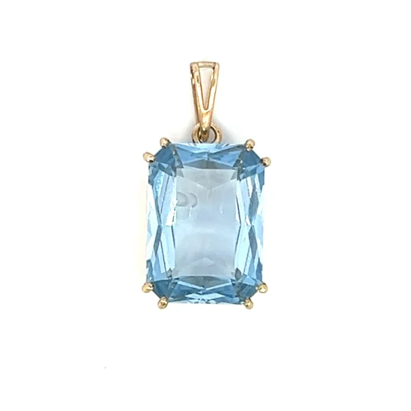 One antique estate 8 karat yellow gold pendant featuring an emerald-cut synthetic blue spinel measuring 13x18mm and weighing 16.30 carats in a double four-prong setting. The entire pendant measures 27x22mm.