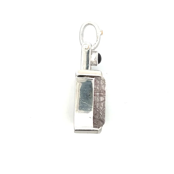 One estate sterling silver gemstone pendant containing a focal rectangle-shaped tourmalated quartz weighing 28.62 carats in a bezel setting and a small round tourmaline weighing 0.84 carat in a bezel setting above the quartz.