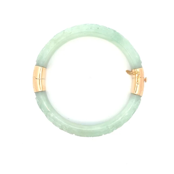 Estate Carved Jadeite Bangle Bracelet - EST 14KYG CARVED GREEN JADEITE BANGLE 1970/80s One (1) estate light green carved jadeite bangle bracelet secured with 14 karat yellow gold button hidden tongue clasp and 2" safety chain and 14k yellow gold hinged opening. diameter of inner opening is 2.2". diameter of entire bracelet is 2.75". total weight of 53.23 grams.