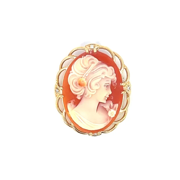 One estate vintage 14 karat yellow gold oval cameo pendant/pin with 4 round brilliant diamonds weighing 0.04 carat total weight with one set at each cardinal point around the cameo in the filigree frame. Stamped "14k" with a total of weight of 8.33 grams.