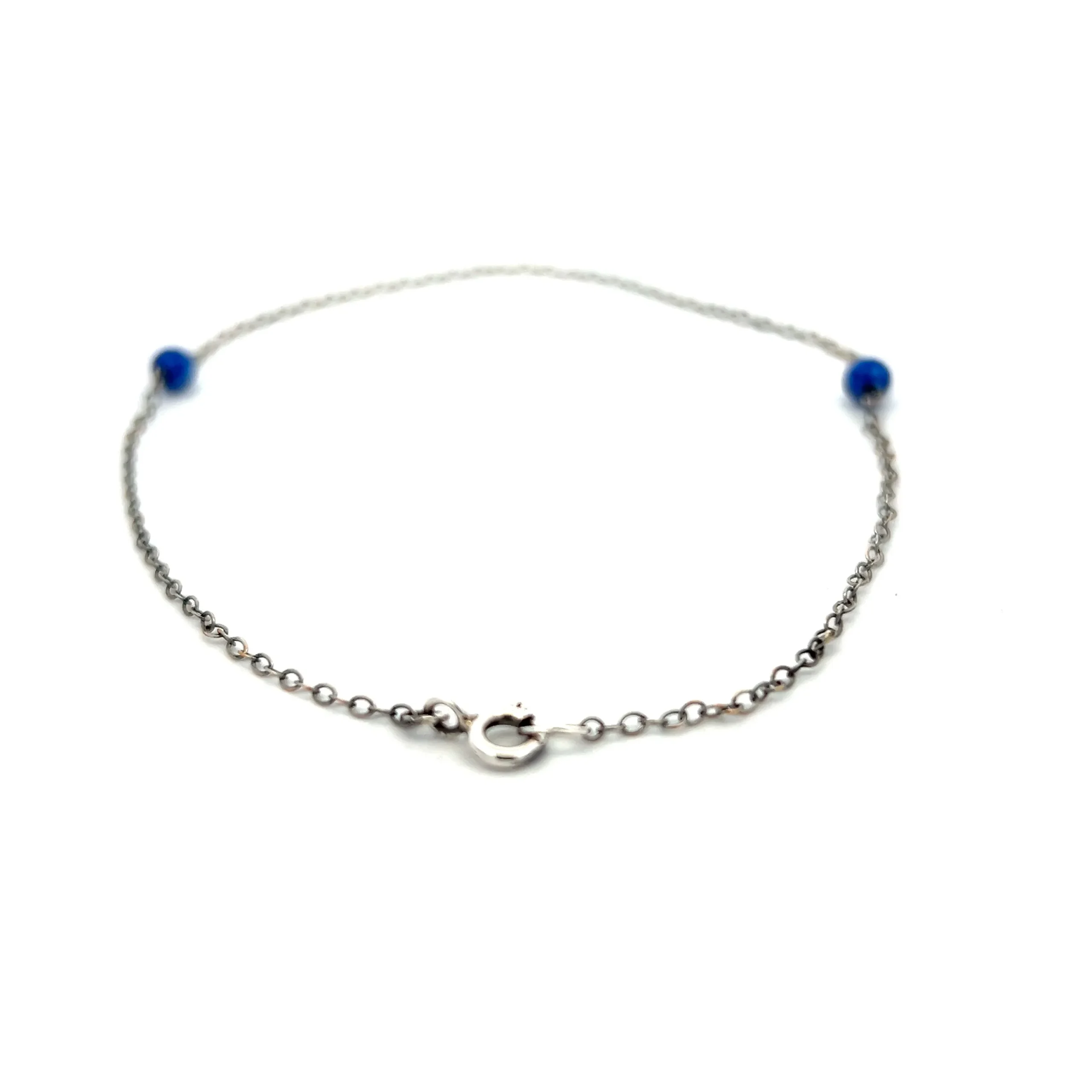 One estate sterling silver anklet with 2 round cabochon lapis lazuli beads measuring 4mm each on a 9.5" anklet. spring ring clasp.