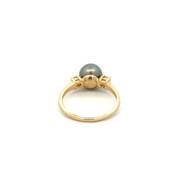 One estate 14 karat yellow gold gray pearl and diamond ring with a center 8.5mm round gray pearl flanked by 2 round brilliant-cut diamonds weighing 0.20 carat total weight with I color and Si2 clarity.
