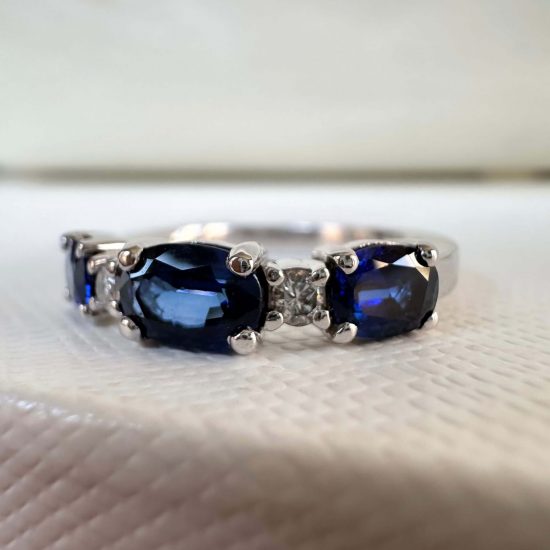 A custom design band with blue sapphires and diamonds